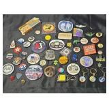Collection of buttons lapel pins keychains and