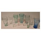 Assorted plastic and glass Coca-Cola glasses