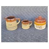 Stoneware measuring cups and sugar bowl.