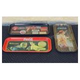 Metal Coca-Cola trays.