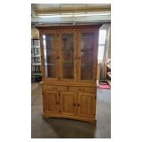 Oak China cabinet with glass doors and shelves