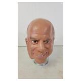 John McCain rubber mask on glass head