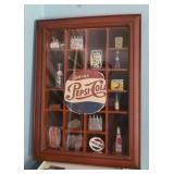 Shadow box of Pepsi Cola collectibles