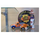 Gulf Motor Oil sign, gas pump bank, trucks