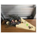 Wall pocket of dried, ceramic flowers