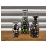 Dairy bottles of marbles (3)