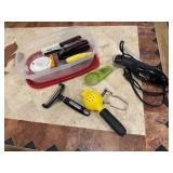 Container of kitchen utensils, electric knife