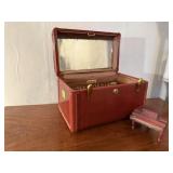 Train case of wooden spools, piano