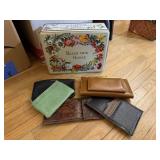 Tin of leather wallets, coin purses