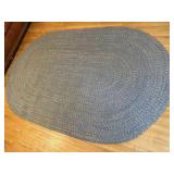 Blue oblong braided rug