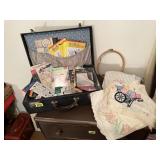 Suitcase of embroidery patterns, tea towels, hoop