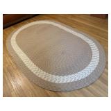 Beige oblong braided rug
