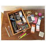 Tray of sewing notions, tape measures, needles