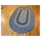 Blue oblong braided rug