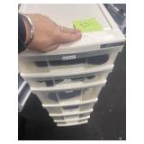 Tall plastic drawers w/ table clothes and linens