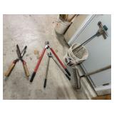 Bucket of yard tools, pruners, shear, rake
