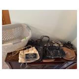 Laundry basket of purses, handbags