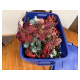 Rubbermaid tote of Christmas florals, greenery