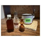 Pottery honey pot, vintage bottles, woven trivet