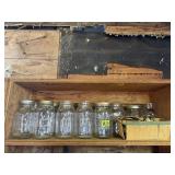Shelf of quart canning jars, lids, rings