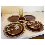 Brown stoneware dishes, plates, soup mug, spoons