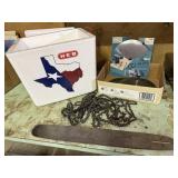 Styrofoam cooler, chainsaw arm, saw blades, chains