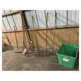 Bin of yard tools, rakes, weeders, shovel