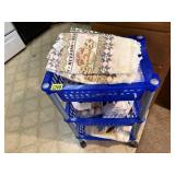 Rolling storage cart of kitchen towels, linens