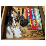 Kitchen utensils, plastic wrap, wax paper