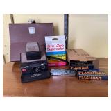 Vintage Polaroid camera, film, flash bulbs