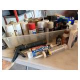 Tote of consumables, spray paint, stains, caulk,