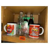 Coca Cola soda bottles, mugs