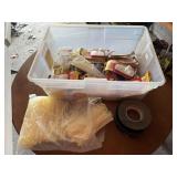Tote of 3M products, wall hooks, zip ties, face