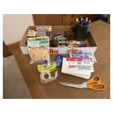 Box of office supplies, scissors, adhesives, hole