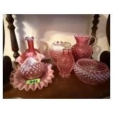 Shelf of pink hobnail, moonstone glassware