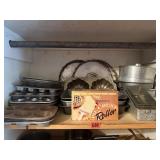Shelf of baking pans, muffin tins, loaf pans