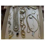 Gold costume necklaces, feather brooch, bracelets