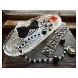 Glass dish of jewelry, bowtie, watch pendant
