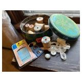 Vintage tin of wooden spools, sewing notions