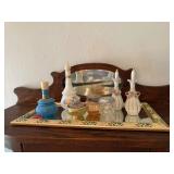 Wall mirror, perfume bottles, vanity jars