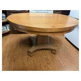 Round oak pedestal dining table