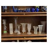 Shelf of crystal, glass floral vases