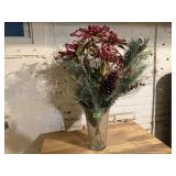 Vase of Christmas florals, greenery