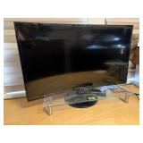 Samsung 32" television, glass riser, remote