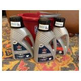 Bucket, jugs of Bissell Pro carpet cleaner (3)