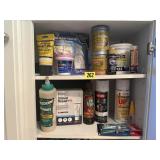 Shelf of consumables, spray paint, adhesives,