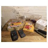 Scientific calculators, stapler, rolls of packing