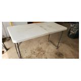folding 4' table, shows slight rust underneath