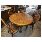 Oak round dining table with claw feet and four