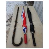 Wooden walking cane and two umbrellas